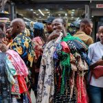 A-man-waits-for-costumers-while-selling-clothes-at-the-Balogun-Market-in-Lagos-on-December-18-2023-2